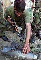 A Pakistan soldier looks at the part of what Pakistan claims is an Indian spy plane