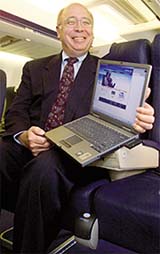 Scott Carson, senior vice president of Boeing, displays a laptop with wireless broadband capability