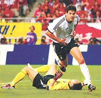 Germanys Michael Ballack celebrates his goal as South Koreas goalkeeper Lee Woon-jae lies on the ground in the World Cup semifinal match in Seoul on Tuesday.