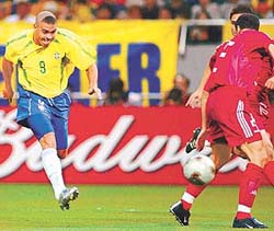 Turkeys Aplay Qzalan watches Brazils Ronaldo as he scores the only goal of their World Cup semi-final match in Saitama on Wednesday. 