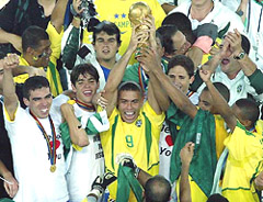 Ronaldo (9) holds up the World Cup trophy