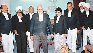 Chief Justice Arun B. Saharya is surrounded by newly appointed Judges
