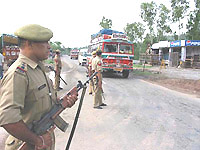 Policemen keep a strict vigil as Amarnath-bound buses carrying pilgrims go along the Jammu-Kashmir highway on Friday.
