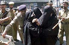 Policemen detain women activists of the All-Parties Hurriyat Conference 