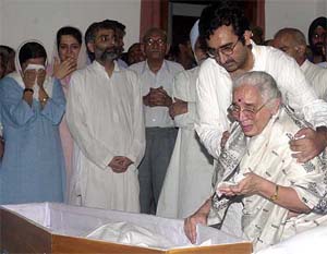A grief stricken Mrs Suman Krishan Kant breaks down near the coffin
