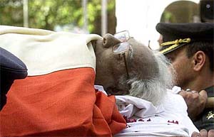 Defence personnel carry the body of Vice-President