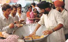 Devotees getting prasad on the birth anniversary of Guru Harkrishan in the Capital.