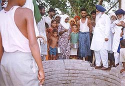 Residents of Thatha village in Tarn Taran stand near a well which has gone dry.