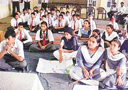 Participants in students’ science seminar listen to a speaker at New Secondary School