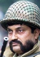 A Paramilitary trooper keeps watch in a busy street in Srinagar, on Wednesday.