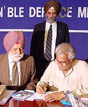 Defence Minister George Fernandes with Marshal of the Indian Air Force Arjan Singh during the launch of  Biography of the Marshal of the Indian Air Force Arjan Singh, DFC, in the Capital on Wednesday. Author Roopinder Singh, Assistant Editor, The Tribune, is also in the picture. — Tribune photo Mukesh Aggarwal