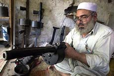 Pakistani tribesman makes a grenade launcher in the Darra Adam Khel tribal area, 47 km from Peshawar