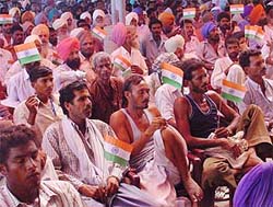 Members of the FCI Workers Union and All-India Food and Allied Workers Union hold National Flags during the visit of the Chief Minister, Capt Amarinder Singh, at a rally in Moga on Sunday