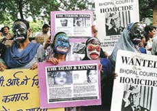 Gas victims wear masks on Tuesday in Bhopal during a demonstration outside the courts