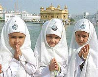 Schoolchildren participate in a nagar kirtan on the Golden Temple premises in Amritsar