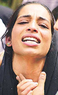 The wife of Mushtaq Ahmad Khan wails after he was killed by gunmen in Srinagar on Sunday.