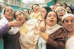 Wailing relatives (wife Bashira in centre) of 60-year-old NC worker Ali Mohd Dar