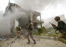 BSF jawans storm a building in Srinagar on Tuesday