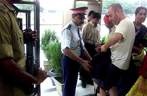 Security personnel frisk a foreigner at Birla Mandir in New Delhi on Wednesday after an all-round alert was sounded