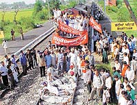 Farmers of different kisan unions lie on the railway track