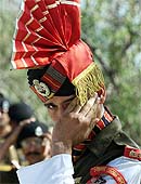 A member of the BSF reacts during a ceremony 