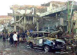 Police officers inspect the ruins of a nightclub destroyed by an explosion