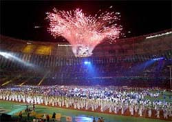 Fireworks explode over Asian athletes and South Korean performers at Busans main stadium during the closing ceremony of the 14th Asian Games