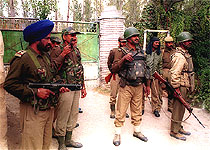Paramilitary jawans stand guard outside the residence of the PDP leader