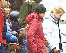A young girl holds her teddy bear as she walks with other children hostage released by Chechen guerrillas out of a theatre in Moscow