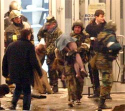 Russian special forces remove hostages from a theatre where Chechen guerrillas were holding hundreds captive in Moscow on Saturday