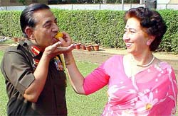 Mrs Rita Vij offers a laddoo to her husband, General N.C. Vij, after he was appointed the next Chief of the Army Staff on Thursday