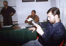 Independent legislator Dhananjay Singh (extreme right) reads papers at Gomti Nagar police station in Lucknow 