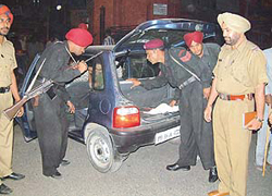 Commandos of the Punjab police check a vehicle entering Amritsar on Friday.