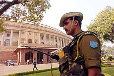 A security personnel takes up position outside Parliament House after a false alert 
