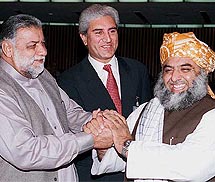 Mir Zafarullah Jamali, newly elected Prime Minister of Pakistan, accepts greetings from Fazal-ur-Rehman, prime ministerial candidate for the Muttahida Majlis-e-Amal (MMA), and Makhdoom Shah Mahmood Qureshi, prime ministerial candidate of Benazir Bhuttos Pakistan Peoples Party