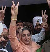 Punjab Agriculture Minister Rajinder Kaur Bhattal comes out of court making a victory sign on Tuesday