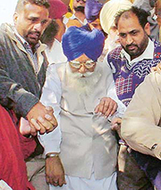 Gurdev Singh Badal comes out of a district courtroom 