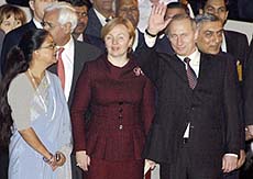 Russian President Vladimir Putin waves to photographers on his arrival in New Delhi on Tuesday