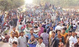 Autorickshaw drivers protesting against the government move to impound three-wheelers without electronic meters