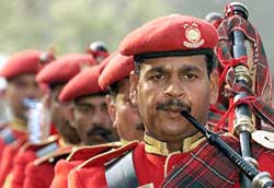 A jawan of the Central Reserve Police Force (CRPF) plays the bagpipes on the 63rd anniversary of the force in New Delhi on Sunday. 