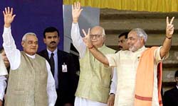 Prime Minister Atal Behari Vajpayee and Deputy Prime Minister Lal Krishan Advani wave with newly sworn-in Gujarat Chief Minister Narendra Modi in Ahmedabad on Sunday.
