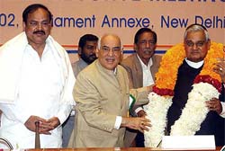 Prime Minister Atal Behari Vajpayee is garlanded by Delhi BJP chief Madan Lal Khurana at the BJP National Executive meeting in New Delhi