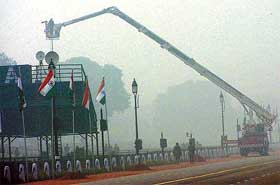 Despite poor visibility because of fog, Army personnel continue to give final touches to the enclosures being constructed for the Republic Day parade at Rajpath on Monday morning