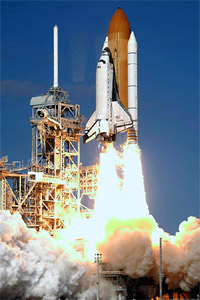 The space shuttle Columbia, with a crew of seven, lifts off from the Kennedy Space Center