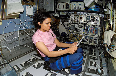 Space Shuttle Columbia Astronaut Kalpana Chawla looks over a procedures checklist