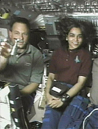 A file photo shows Israeli astronaut Ilan Ramon reaching for a small Kiddush cup