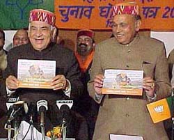 Mr Madan Lal Khurana and Mr Prem Kumar Dhumal release the BJP manifesto in Shimla on Thursday.
