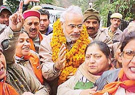 Gujarat Chief Minister Narendra Modi is garlanded on his arrival in Shimla for the Himachal election campaign 