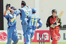 Harbhajan Singh celebrates with teammates the dismissal of Zimbabwe batsman Andy Flower for 22 runs 