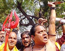 Holding trishuls, sants raise slogans